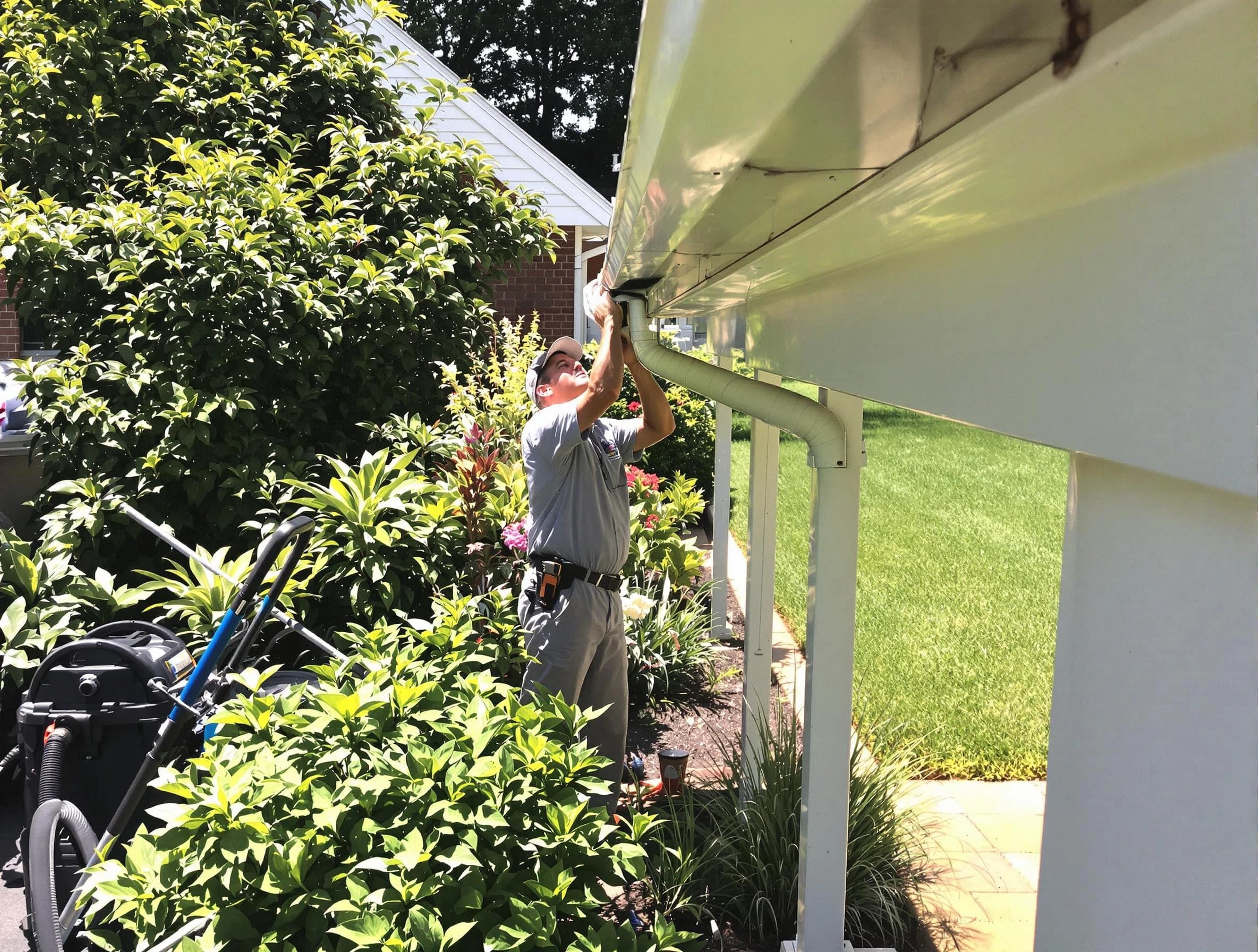 Technician flushing a blockage from a downspout in Brunswick, OH